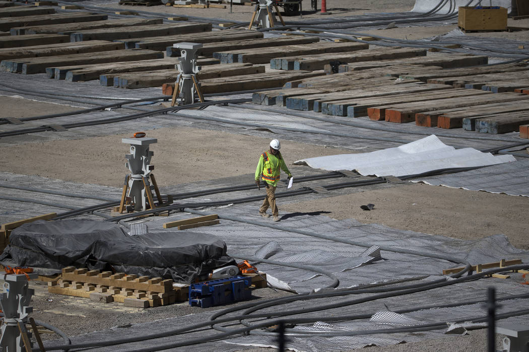 A workers walks the floor level of the Raiders Allegiant Stadium construction site in Las Vegas ...