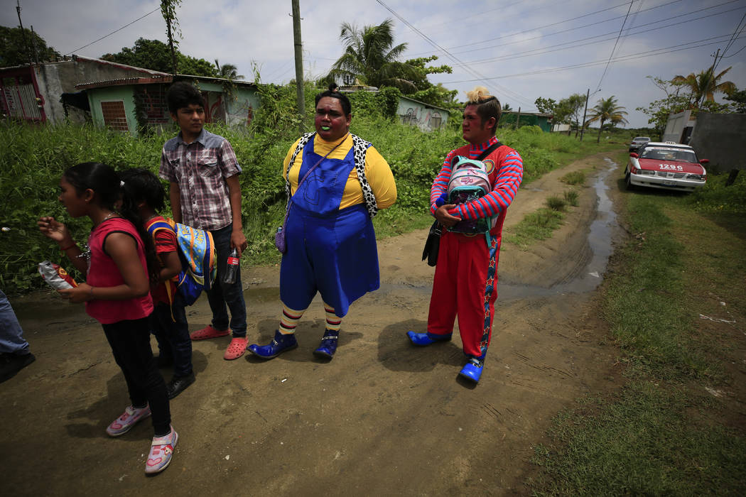 Clowns who were friends from the neighborhood gather with other mourners for the wake of Erick ...