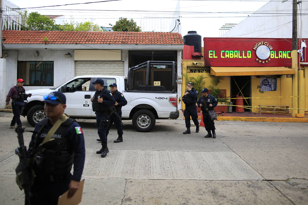 Police cordon off the White Horse nightclub (El Caballo Blanco in Spanish), the scene of a Tues ...