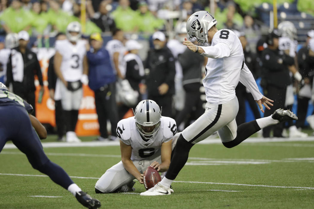 Oakland Raiders kicker Daniel Carlson (8) kicks a field goal as punter A.J. Cole holds during t ...