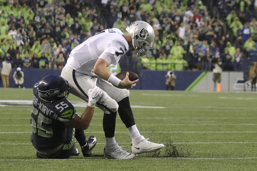 Seattle Seahawks linebacker Ben Burr-Kirven (55) sacks Oakland Raiders quarterback Mike Glennon ...