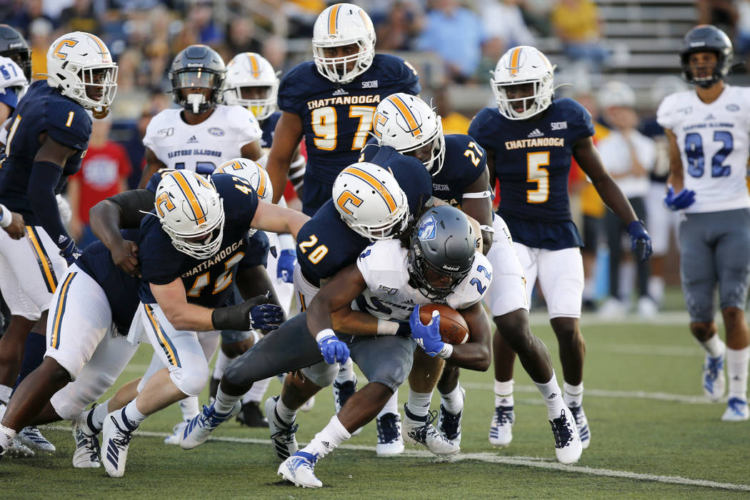 Chattanooga linebacker Kayne Roberts (20) tackles Eastern Illinois running back Courtney Rowell ...