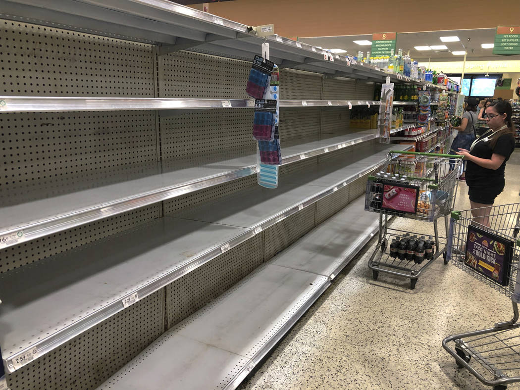Store shelves are empty of bottled water as residents buy supplies in preparation for Hurricane ...