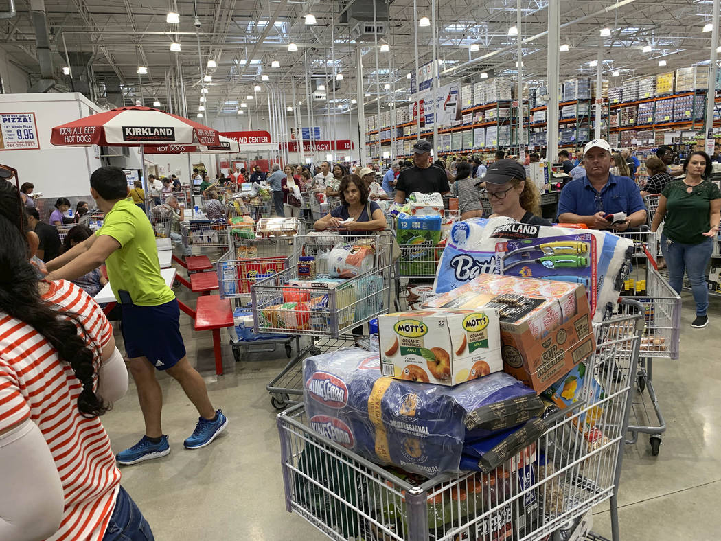 Shoppers wait in long lines at Costco, Thursday, Aug. 29, 2019, in Davie, Fla., as they stock u ...