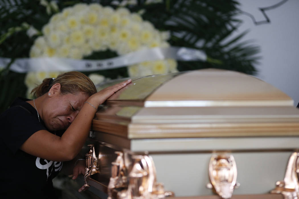 Vanessa Galindo Blas grieves on the coffin that contains the remains of her late husband Erick ...