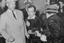 n this Nov. 24, 1963 file photo, Lee Harvey Oswald reacts as Dallas night club owner Jack Ruby, ...