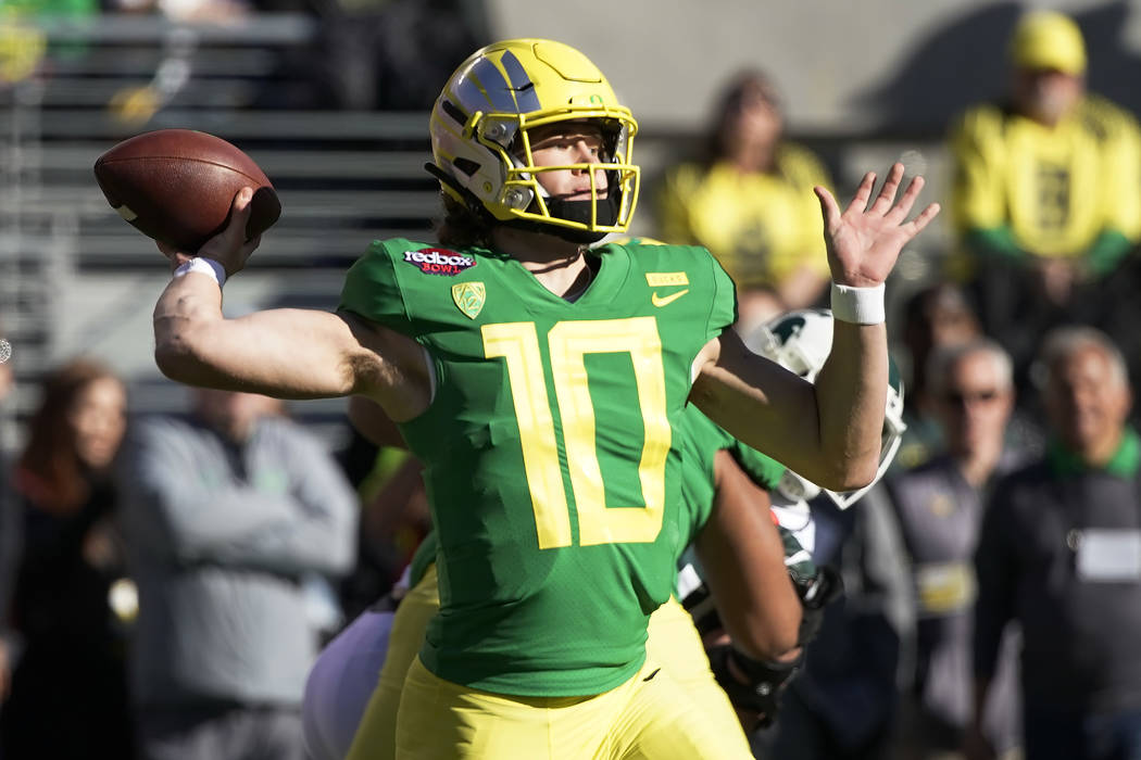 In this Dec. 31, 2018, file photo, Oregon quarterback Justin Herbert throws a pass during the f ...