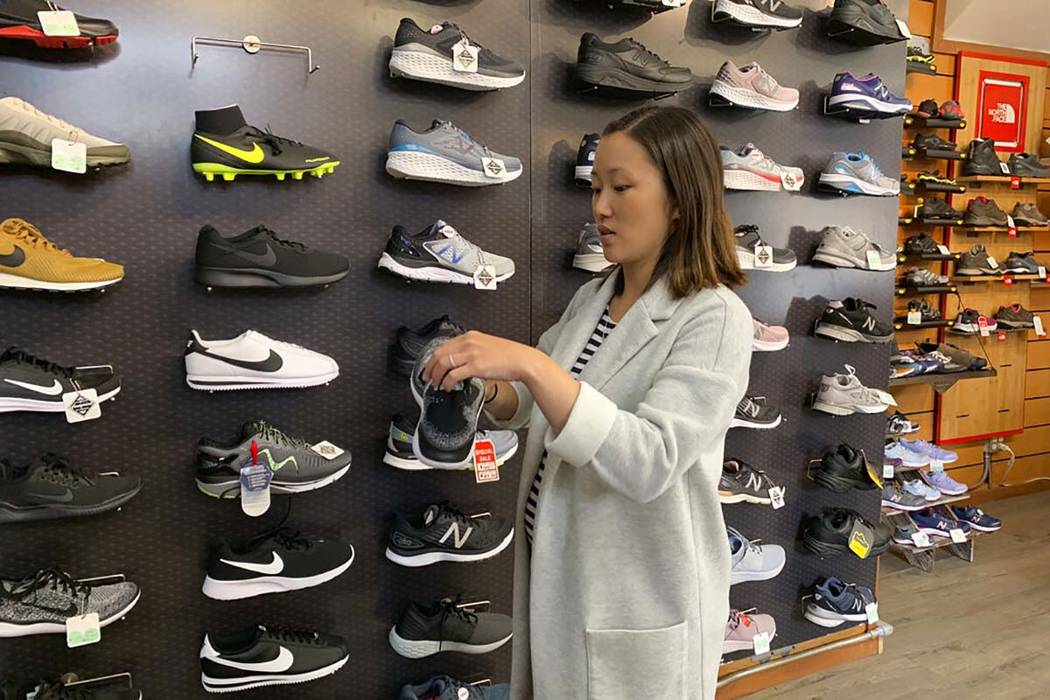 In this photo taken Wednesday, Aug. 28, 2019, Jennifer Lee, whose family owns Footprint shoe st ...