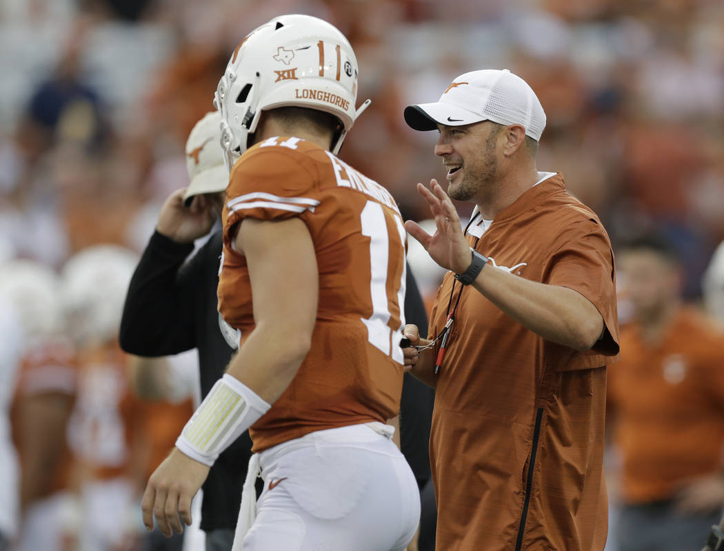 Texas head coach Tom Herman, right, with Texas Longhorns quarterback Sam Ehlinger (11) before a ...