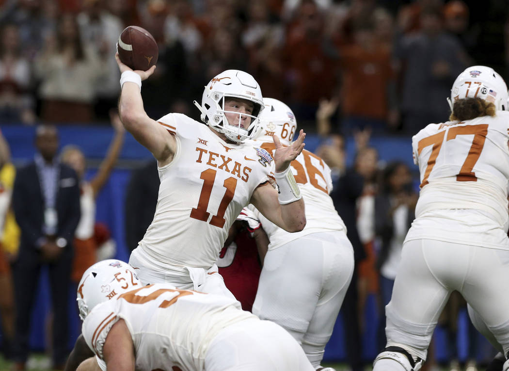 Texas quarterback Sam Ehlinger (11) throws a pass during the first half of the Sugar Bowl NCAA ...