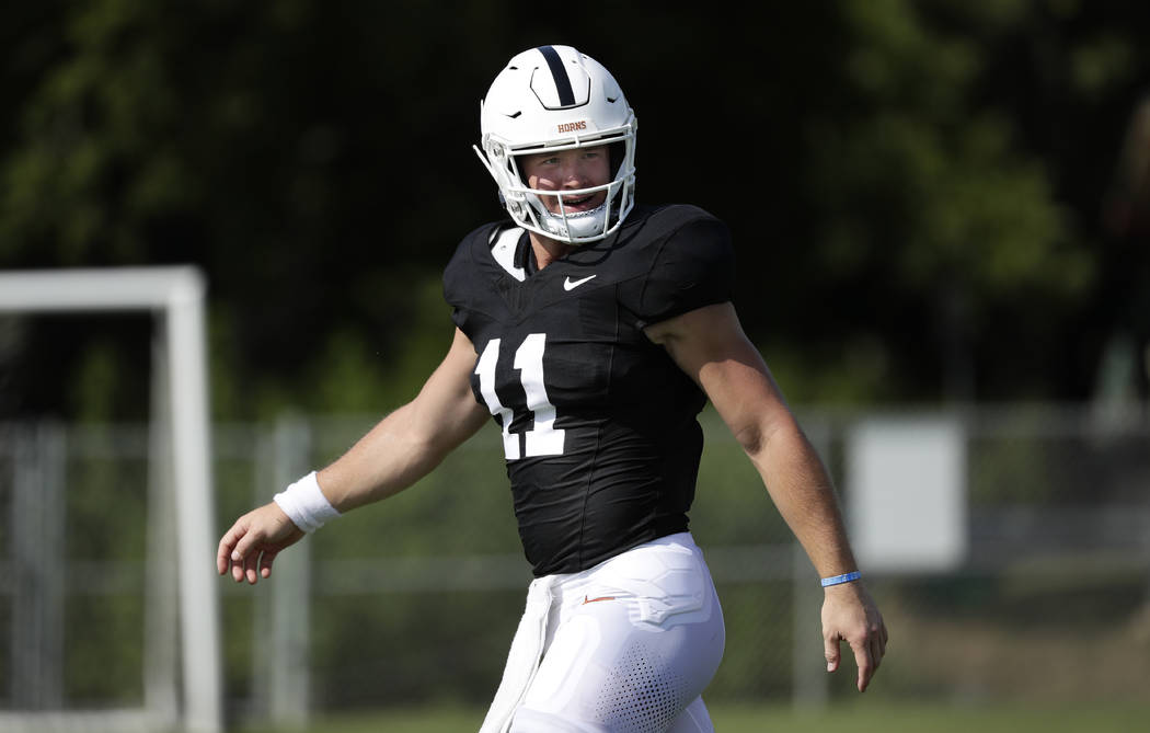 Texas quarterback Sam Ehlinger takes part in a morning practice at the team's facility in Austi ...