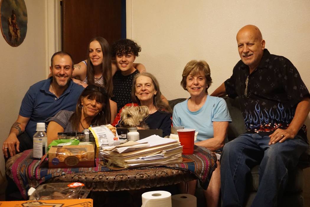 In this recent photo, Gail Sacco sits at the table with her family. From left to right: her son ...