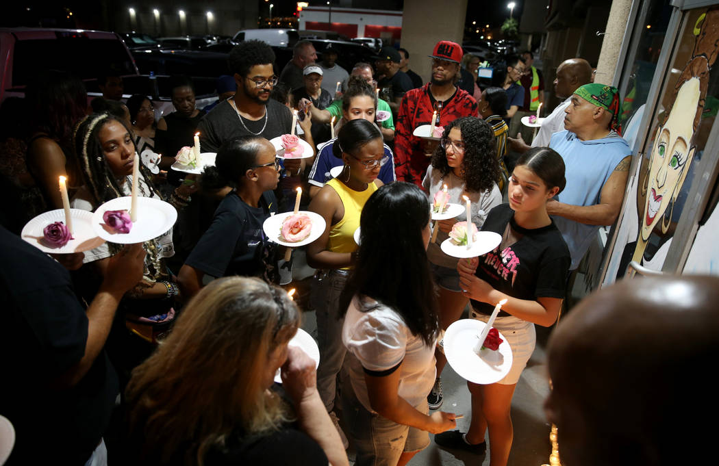 Mourners gather during a vigil Friday, Aug. 30, 2019, at TC's World Famous Rib Crib in Las Vega ...