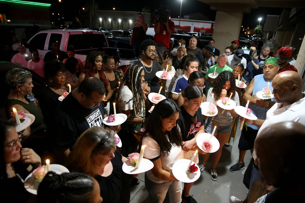 Mourners gather during a vigil Friday, Aug. 30, 2019, at TC's World Famous Rib Crib in Las Vega ...