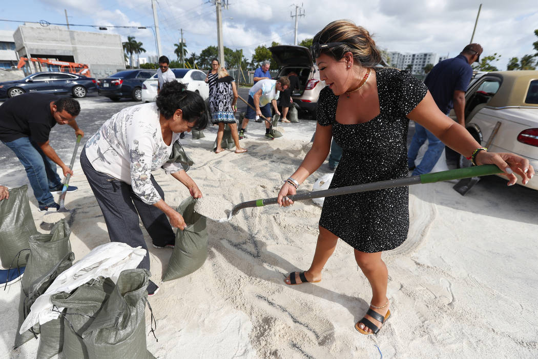 Georgia Bernard, right, and Ana Perez are among residents filling sandbags to take home in prep ...