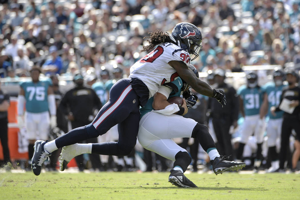 In this Oct. 21, 2018, file photo, Jacksonville Jaguars quarterback Cody Kessler is sacked by H ...