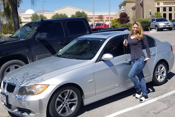 Katrina Sandy, 37, is pictured standing next to her car. (Courtesy of Chris Belcourt)