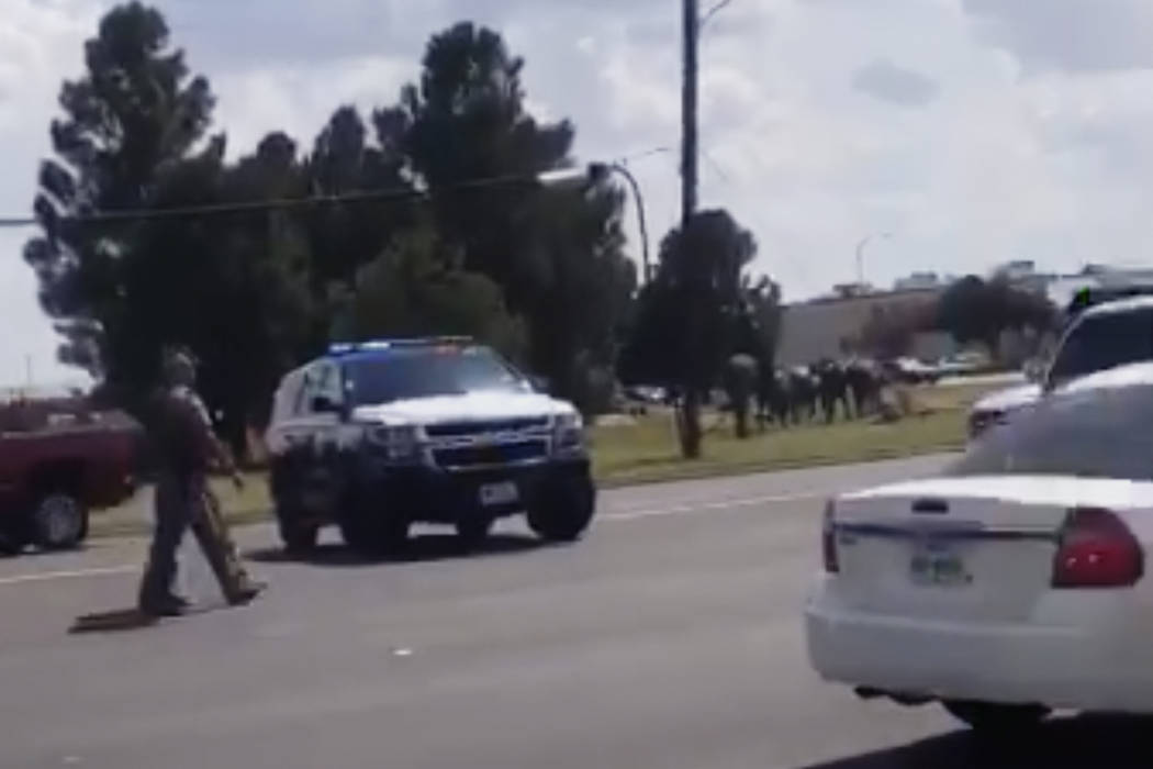 In this image made from video provided by Dustin Fawcett, police officers guard on a street in ...