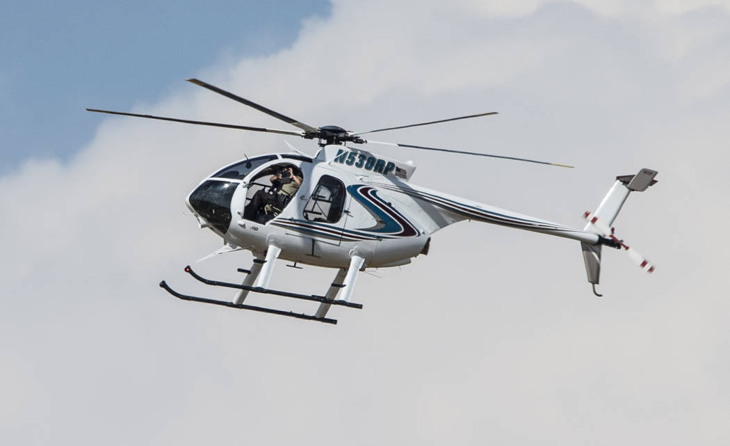 An authorities chopper flies over an area in Odessa, Texas, Saturday, Aug. 31, 2019, after repo ...