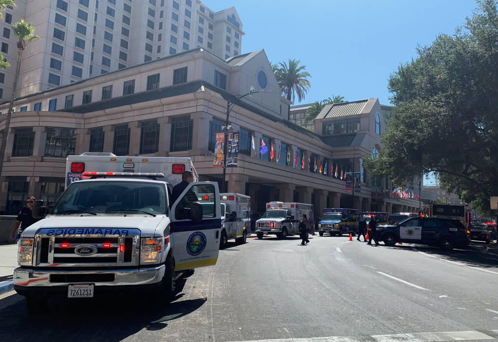 Fire crews gather on Market Street outside the Hotel Fairmont in downtown San Jose, Calif., aft ...