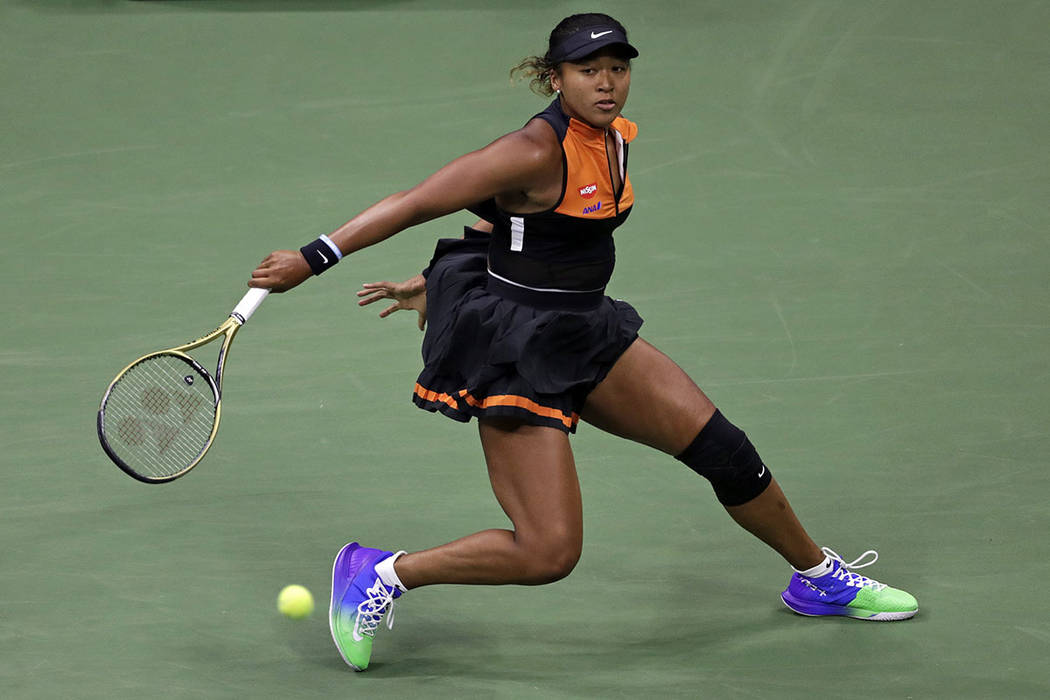 Naomi Osaka, of Japan, returns a shot to Coco Gauff during the third round of the U.S. Open ten ...