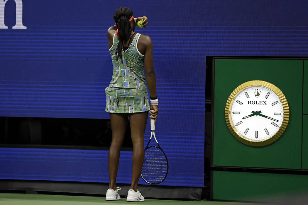 Coco Gauff wipes her face during a match against against Naomi Osaka, of Japan, in the third ro ...