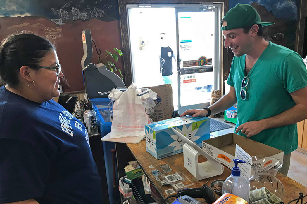 Jeremy Keesh, a Burning Man attendee from Chicago, buys coconut water at the Empire Store from ...