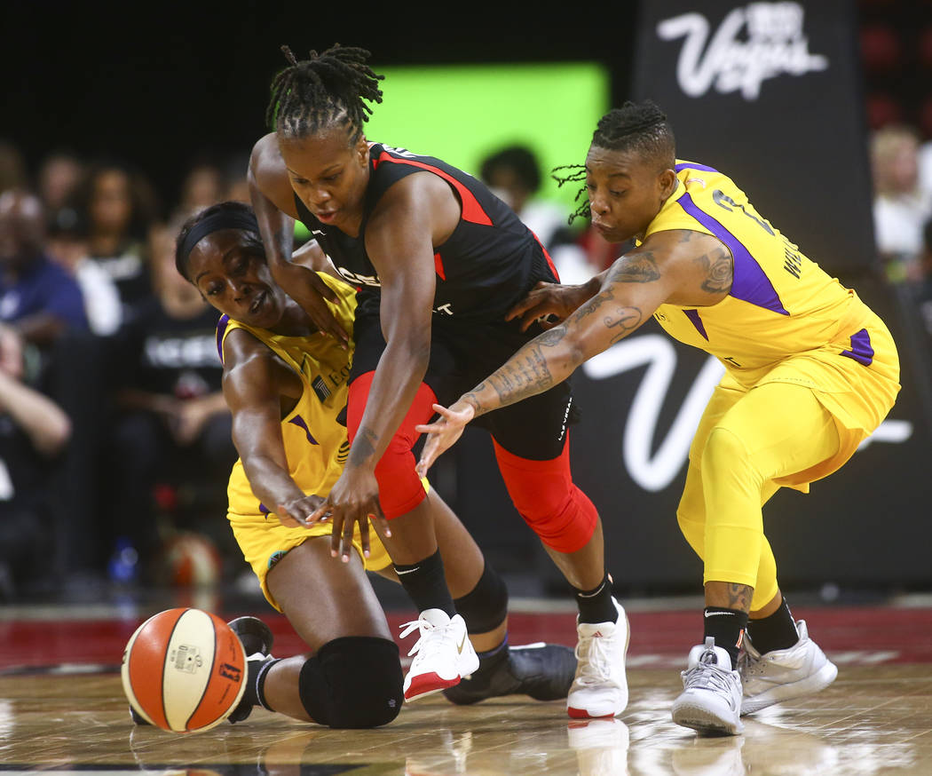 Las Vegas Aces' Epiphanny Prince battles for the ball between Los Angeles Sparks' Chiney Ogwumi ...