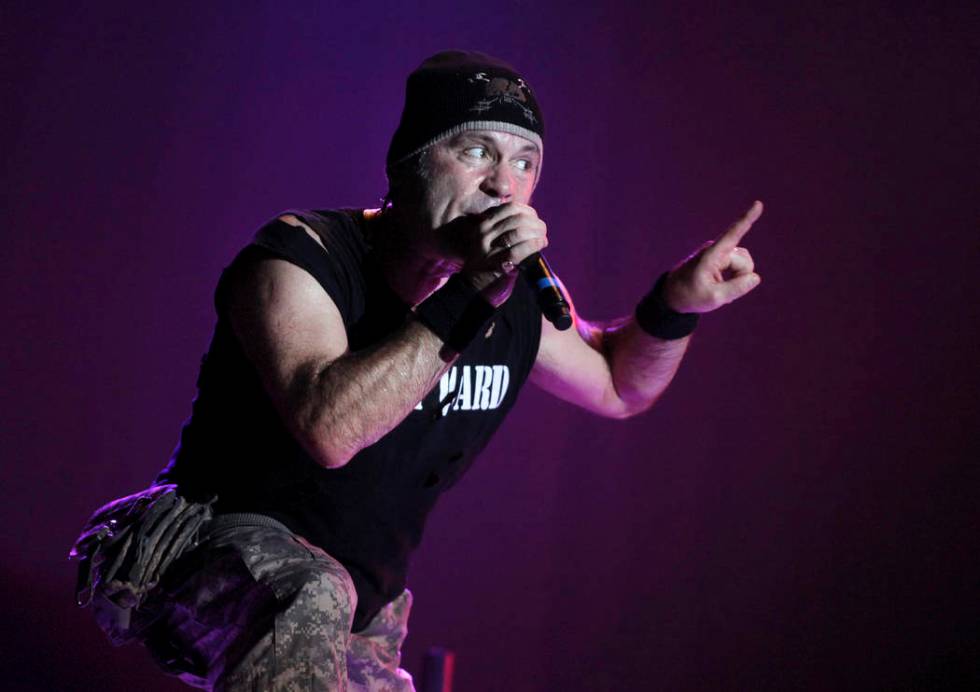 In this photo taken Saturday, Aug. 14, 2010, singer Bruce Dickinson of Iron Maiden performs at ...