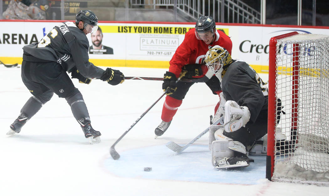 Vegas Golden Knights defender Kaedan Korczak, from left, forward Cole MacKay and goalie Jiri Pa ...