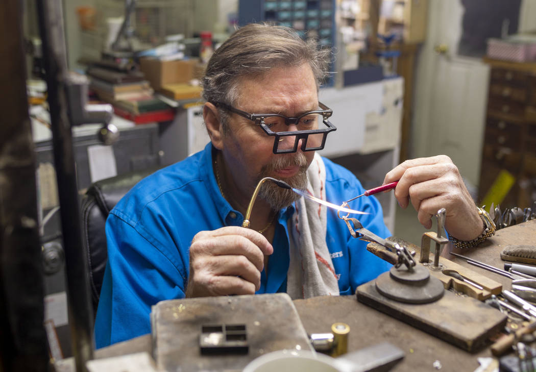 Gold Casters Jewelry owner Michael Holland prepares a wedding ring to be set in his workshop at ...