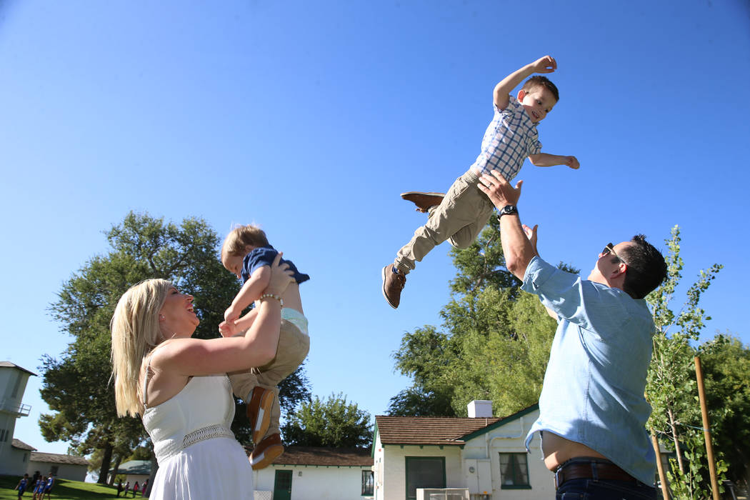 Charlie Bayley, from left, with her son Noah, 1, and husband Steve, with her son Logan, 4, play ...