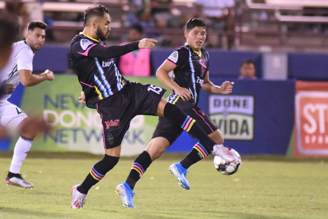 Lights defender Bryan De La Fuente (15) controls the ball as his teammate Cristian Martinez loo ...