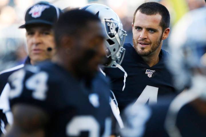 Oakland Raiders quarterback Derek Carr (4) and teammates warm up for an NFL preseason football ...