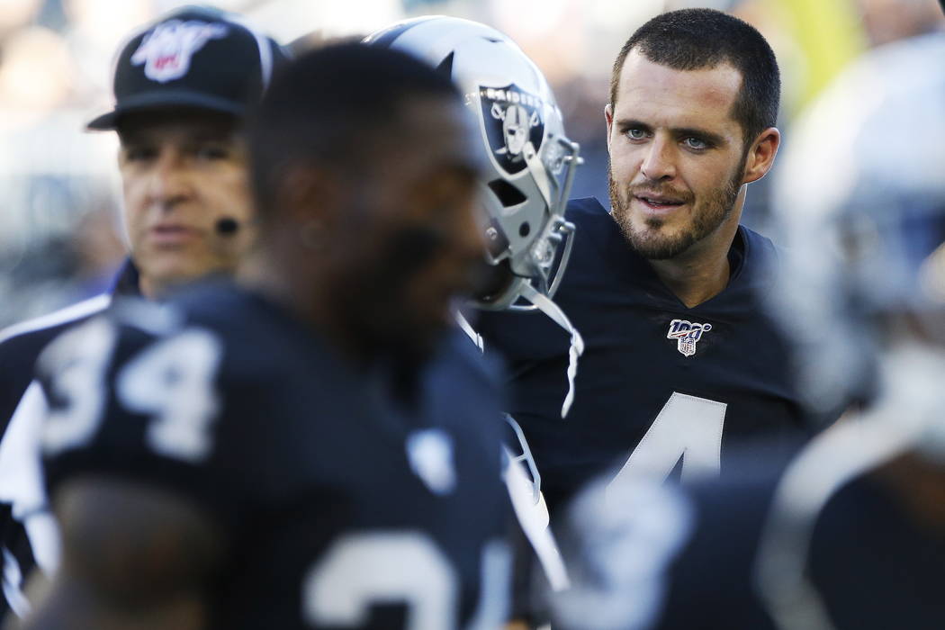 Oakland Raiders quarterback Derek Carr (4) and teammates warm up for an NFL preseason football ...