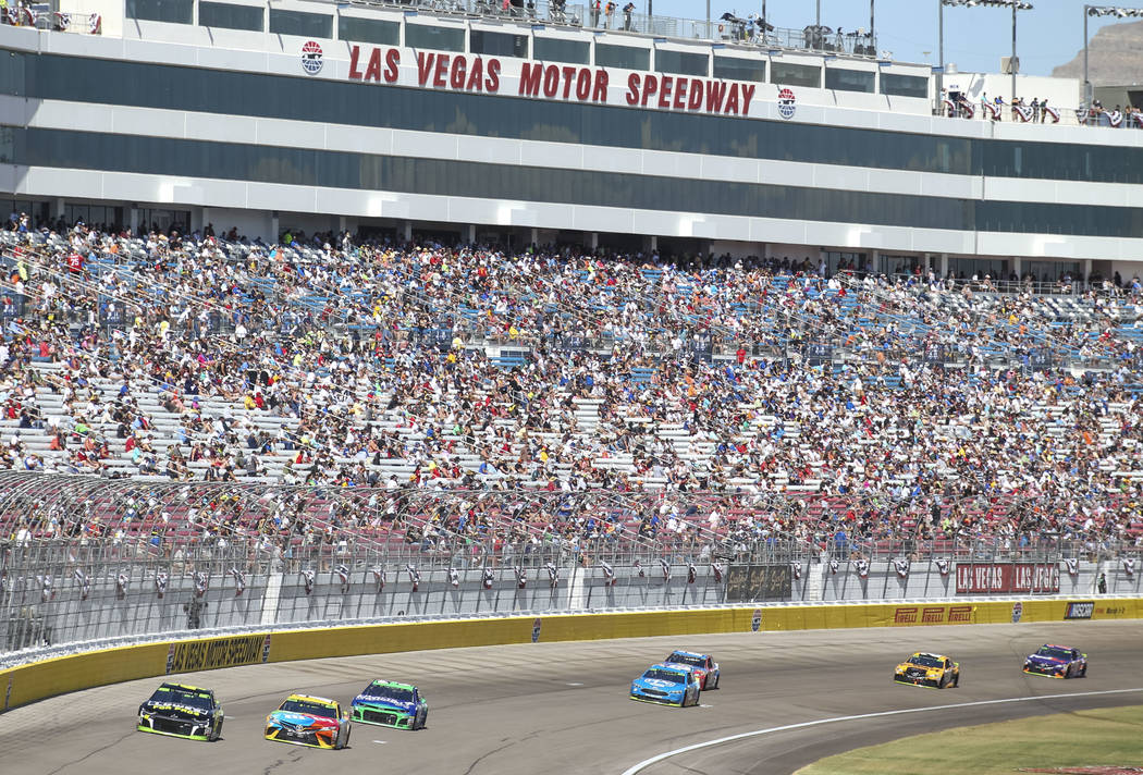 Race fans watch the South Point 400 NASCAR Cup Series auto race at the Las Vegas Motor Speedway ...