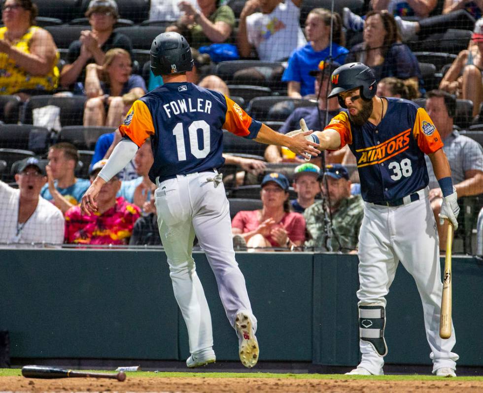 Las Vegas AviatorsÕ runner Dustin Fowler (10) is congratulated by teammate Nick Martini (3 ...