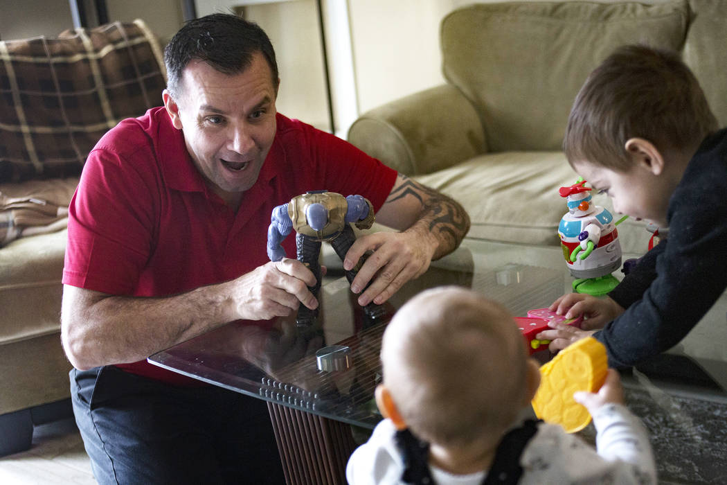 Michael Russell plays with his great-nephew Cameron Gonzales, 2, and great-niece Ava Gonzales, ...