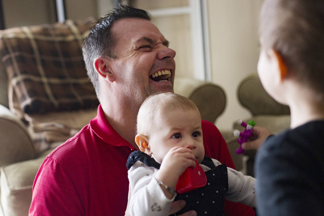 Michael Russell plays with his great-niece Ava Gonzales, 11 months old, at his home in Las Vega ...