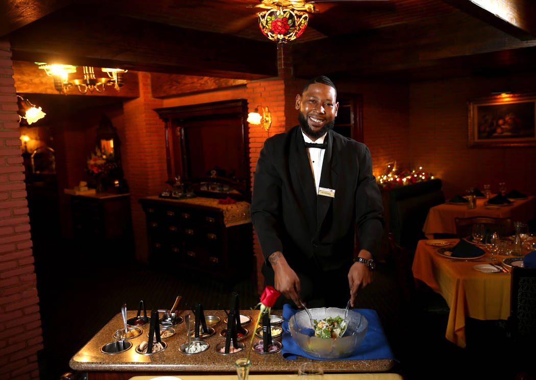 Rashard Miller, 36, of Las Vegas makes a Caesar salad tableside at Hugo's Cellar at Four Queens ...