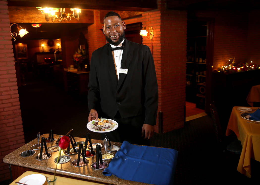 Rashard Miller, 36, of Las Vegas makes a Caesar salad tableside at Hugo's Cellar at Four Queens ...