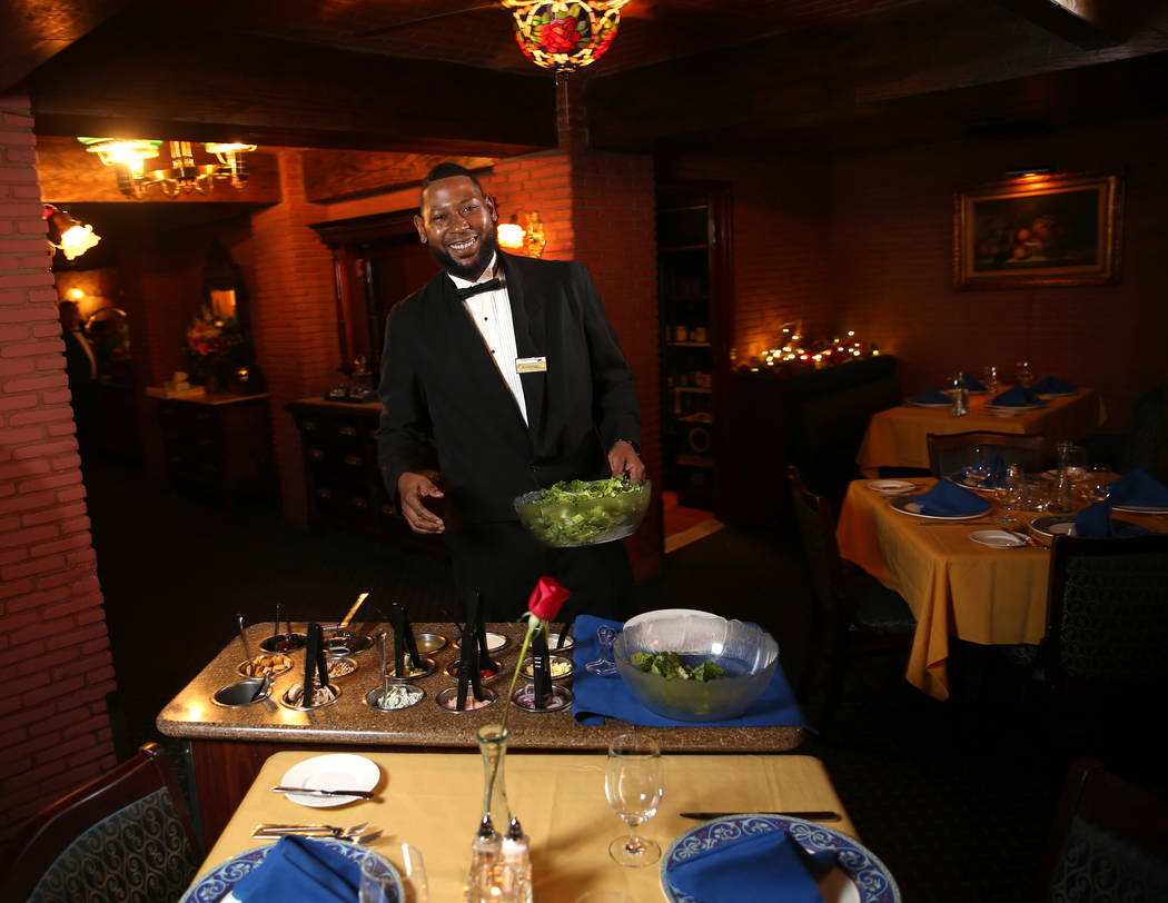 Rashard Miller, 36, of Las Vegas makes a Caesar salad tableside at Hugo's Cellar at Four Queens ...
