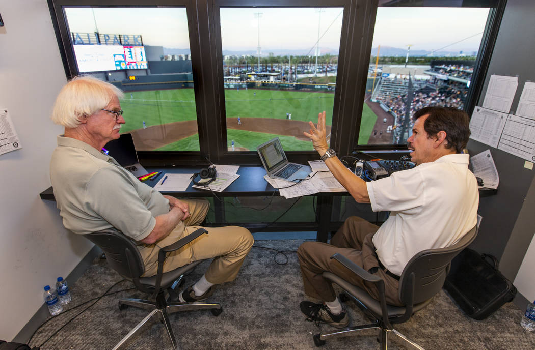 Jerry Reuss, left, and Russ Langer talk baseball on a break in their radio broadcast during the ...