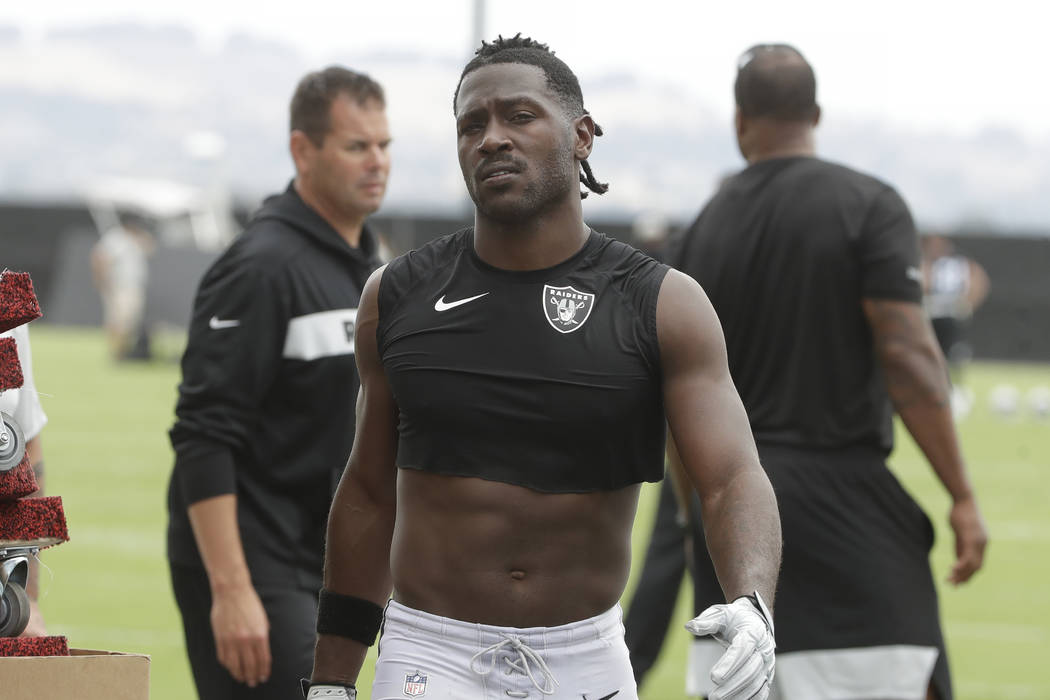 Oakland Raiders' Antonio Brown walks off the field after NFL football practice in Alameda, Cali ...