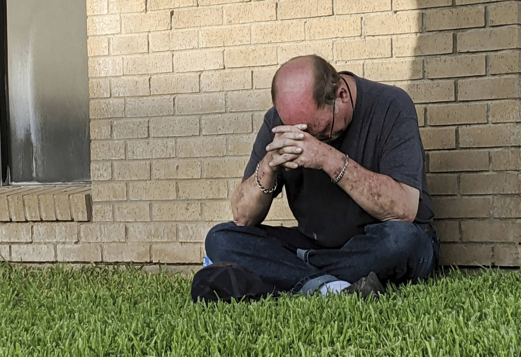 A man prays outside of the Medical Center Hospital Emergency room in Odessa, Texas, Saturday, A ...