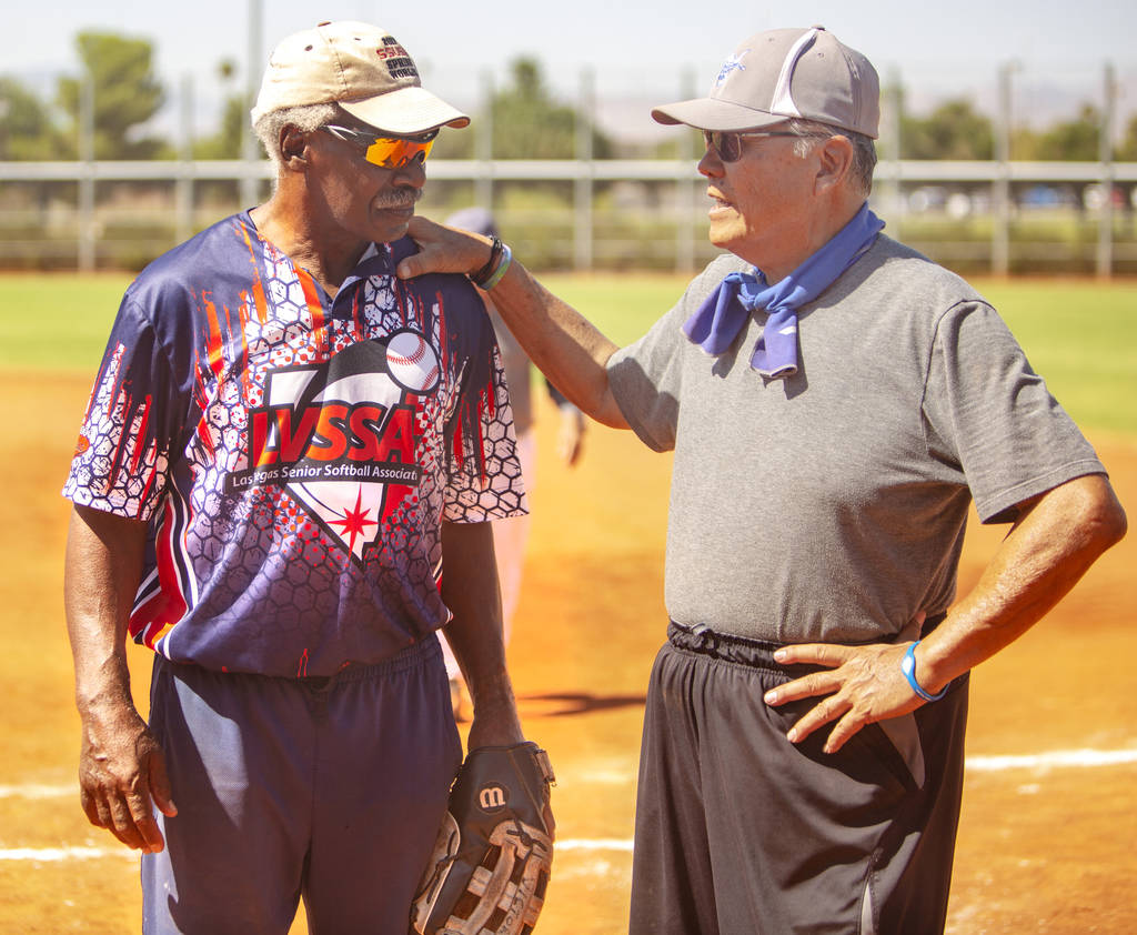 Ken Victory, 79, left, and Robert Tony Ching, 70, right, discuss a play during a baseball game ...