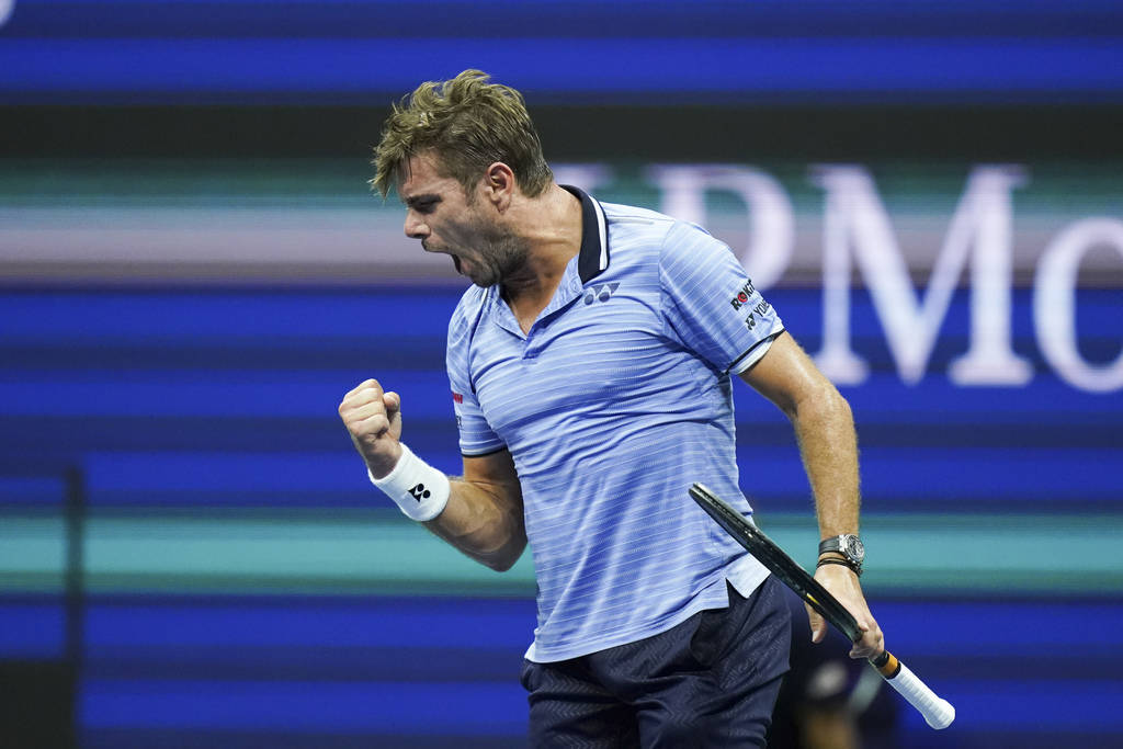 Stan Wawrinka, of Switzerland, celebrates after winning the first set against Novak Djokovic, o ...