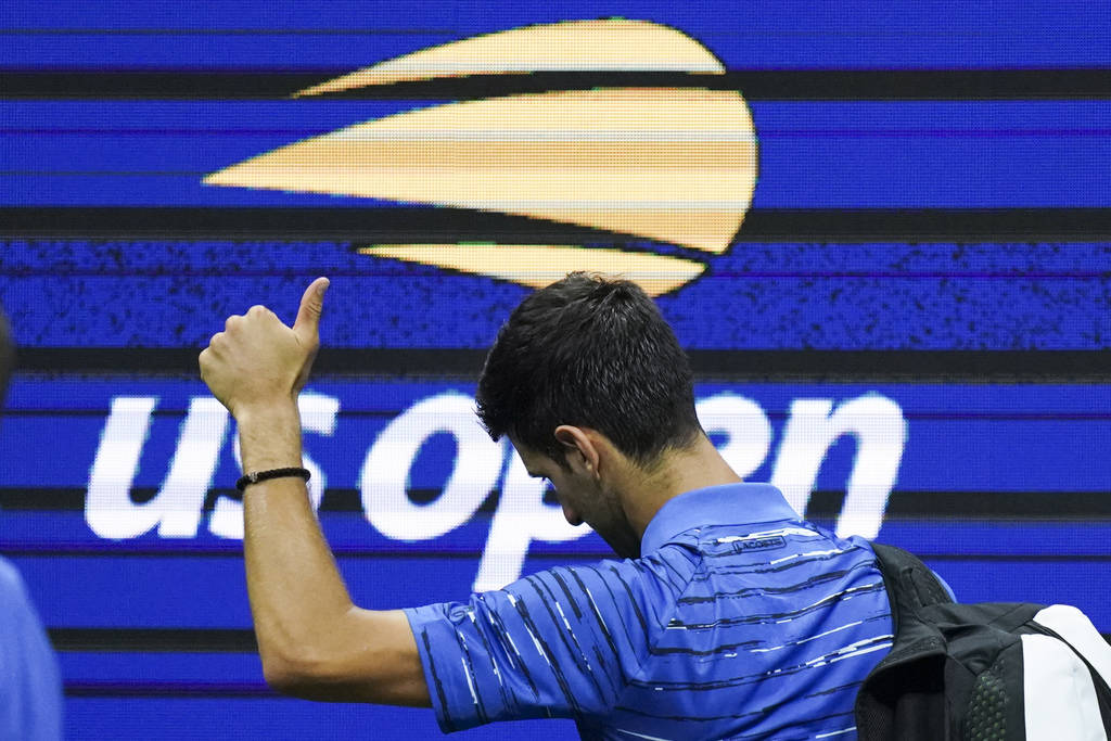 Novak Djokovic, of Serbia, walks off the court as he retires during his match against Stan Wawr ...