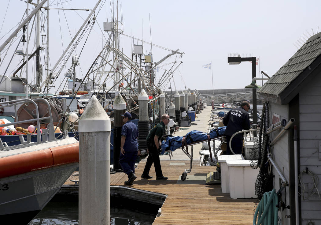 Santa Barbara City Search and Rescue along with Santa Barbara Sheriff officers move a recovered ...