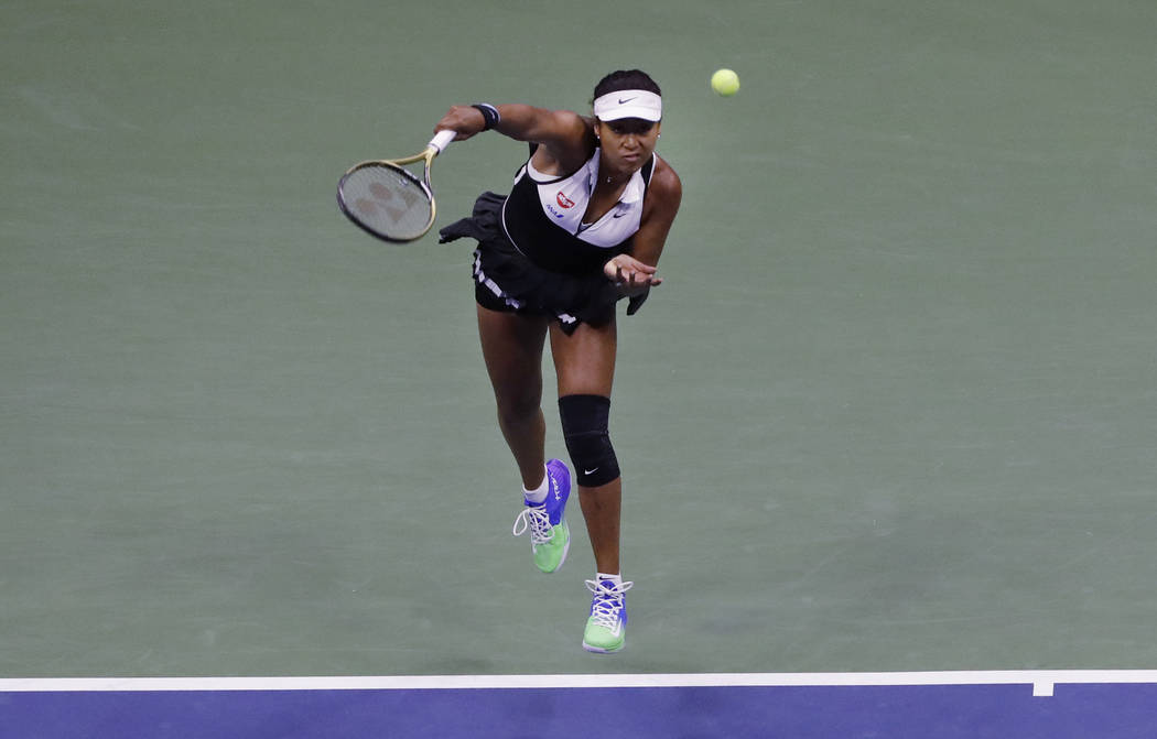 Naomi Osaka, of Japan, serves against Belinda Bencic, of Switzerland, during the fourth round o ...